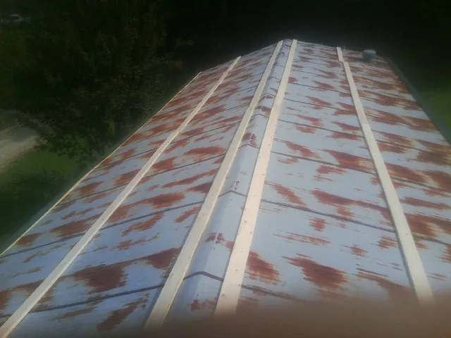 Rusted metal roof panels with new wood purlins before replacement — Storm Damage Roof Repair in Clarks Mills by Roofing Brothers