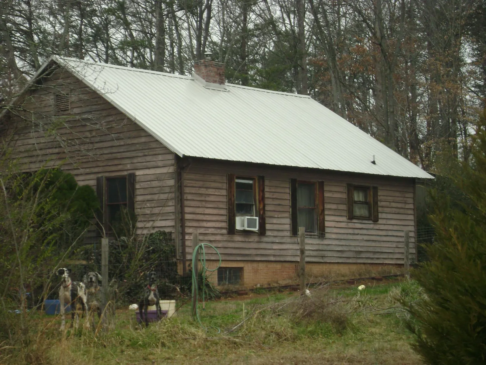 White metal roof on an old wood sided farmhouse, from a Metal Roof Installation job in Clarks Mills